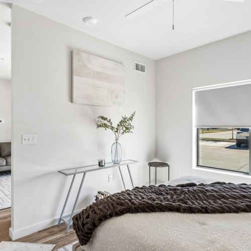 a bedroom with a large window